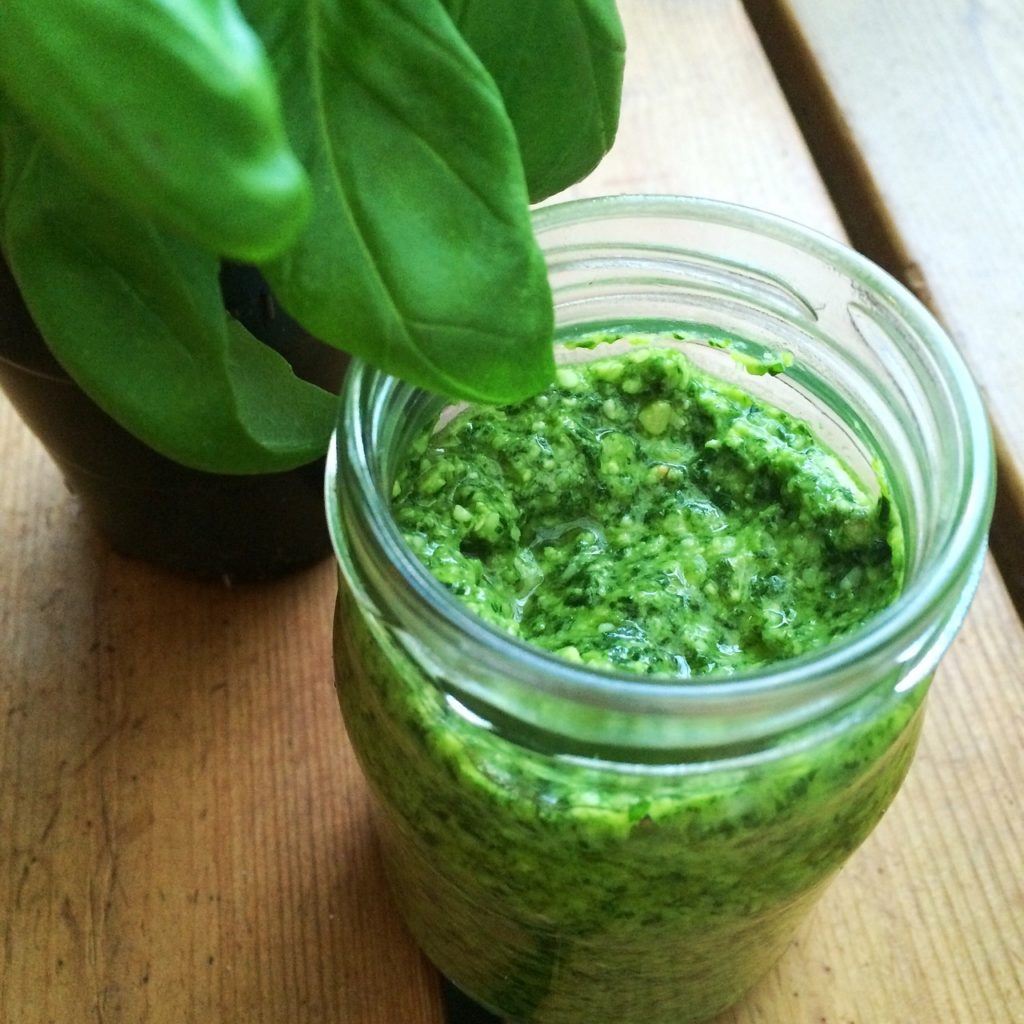 Image of a jar filled with basil pesto